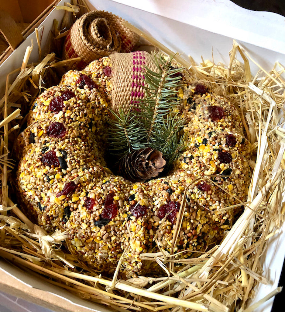 Our most popular large wreath comes nestled in straw and ready for gifting! It can be placed outdoors flat on it's bed of straw or hung with our repurposed burlap furniture strapping! 